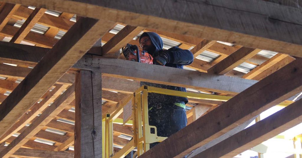 Wood from the barn is being removed one board at a time.