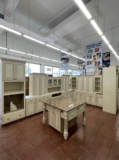 Photo of various white cabinets and a white kitchen island for sale