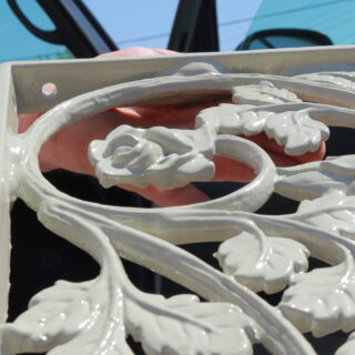 With a little elbow grease and a coat of glossy enamel paint, the intricate rose and leaf details on the brackets now pop!
